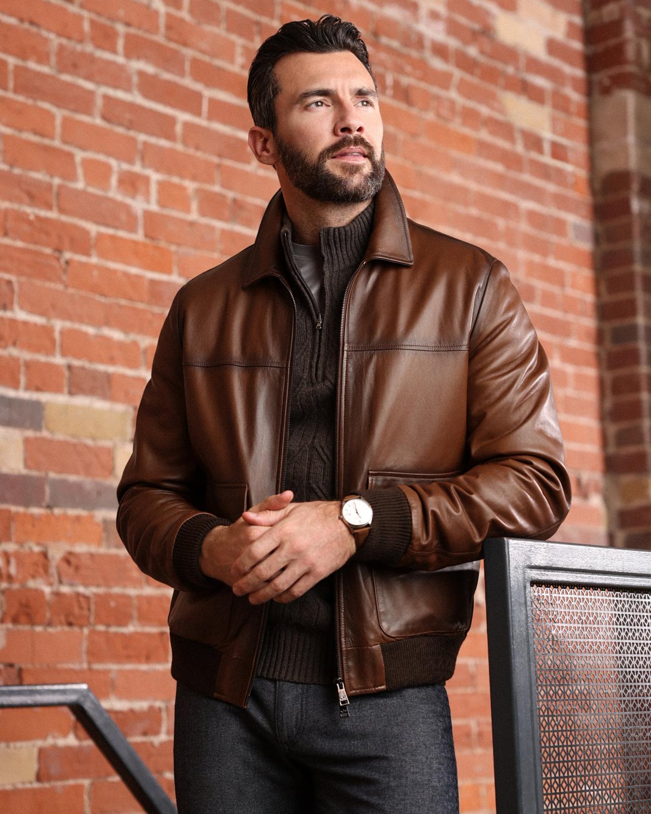 A male model wearing a brown leather jacket