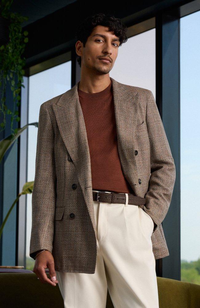 a model wearing a tailored brown check blazer