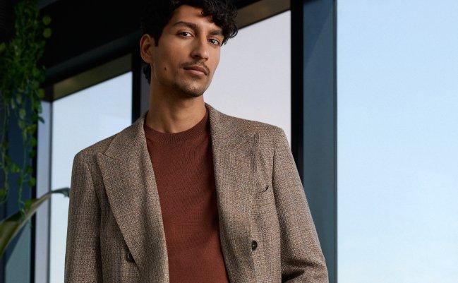 a model wearing a tailored brown check blazer