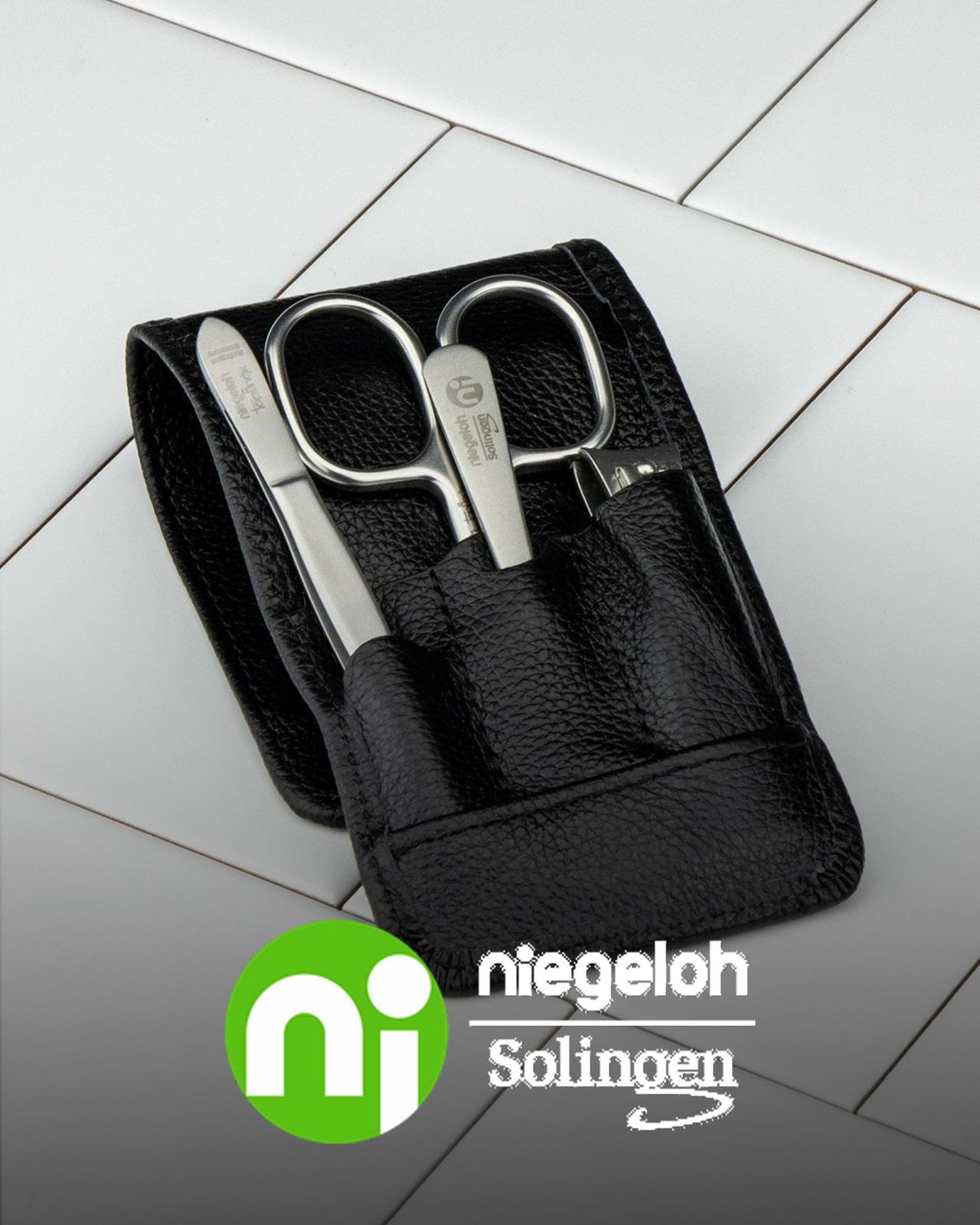 niegeloh grooming pack opened on white tiles showcasing scissors and tweezers