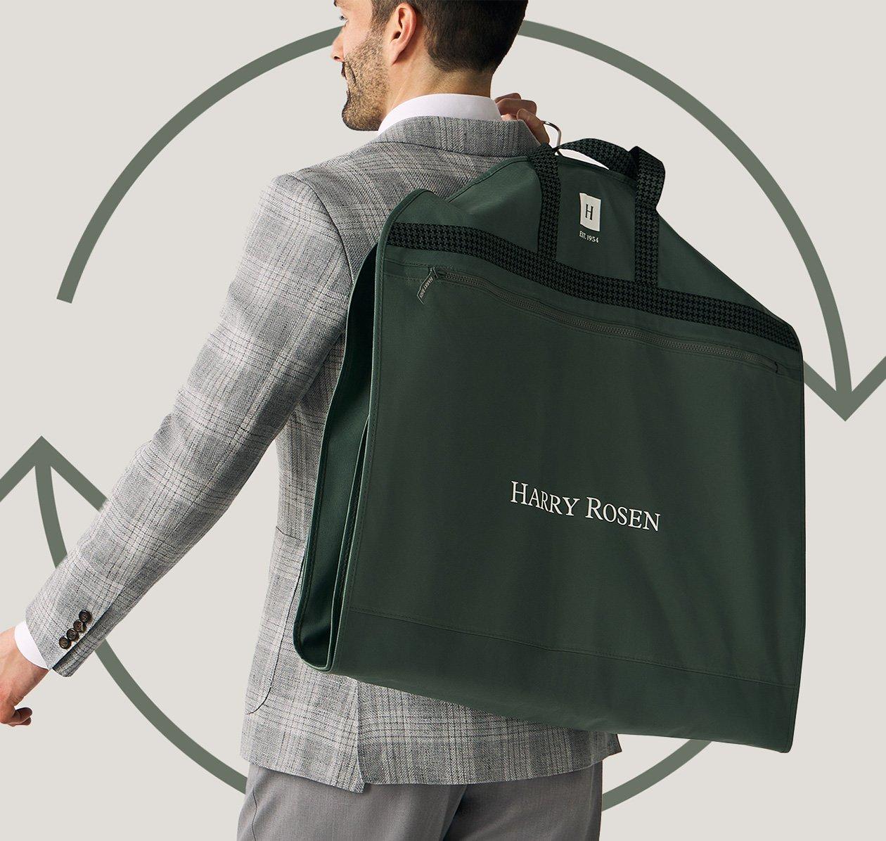 A man in a suit carrying a bag with a Terracycle logo on it