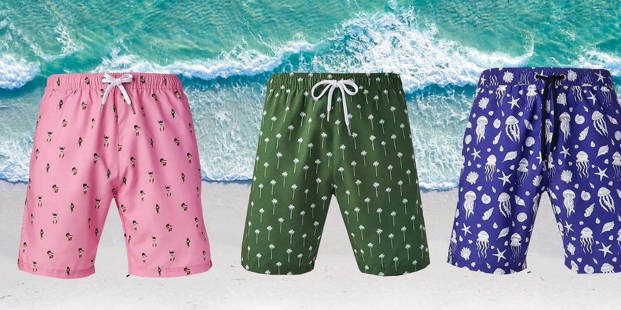 Three patterned men's swimsuits against beach background