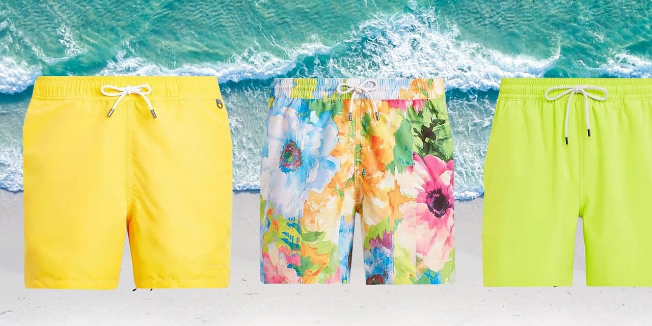 Three vibrant and patterned men's swimsuits against beach background