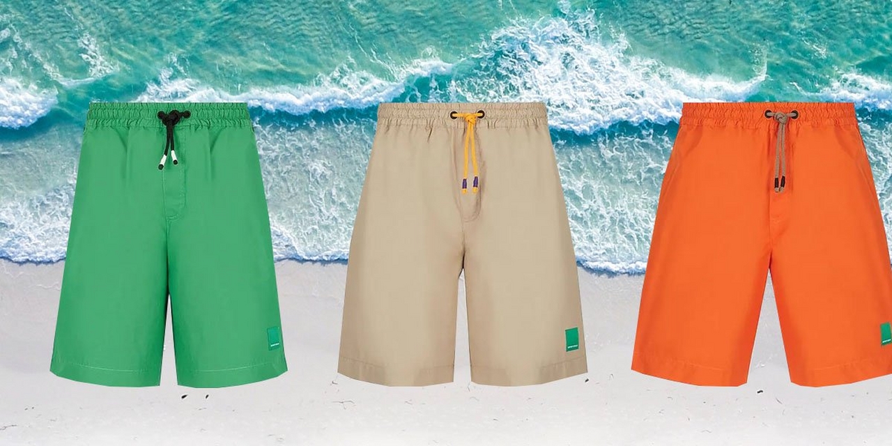 Three board short men's swimsuits against beach background
