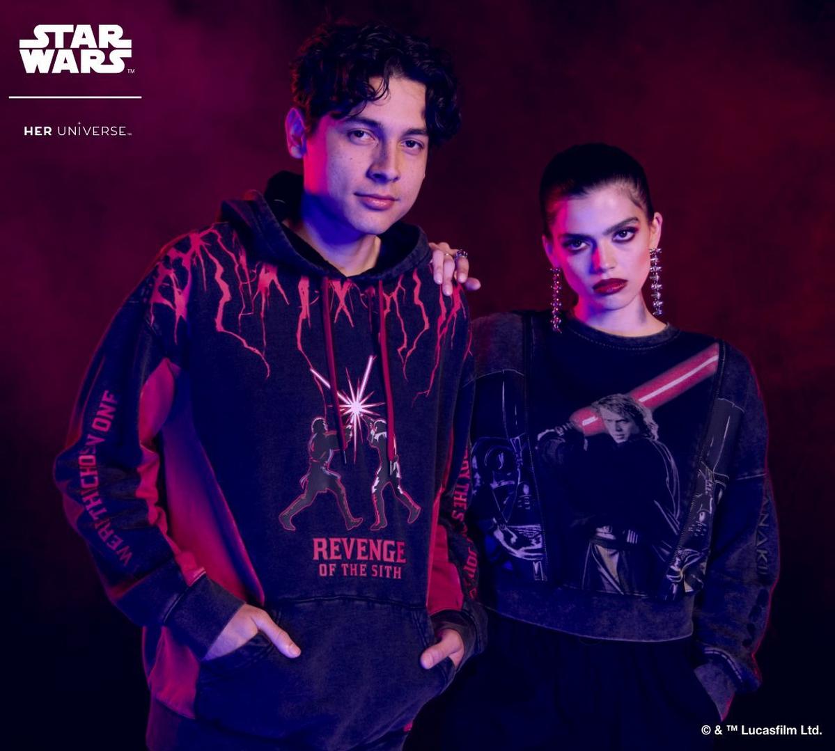 Man wearing revenge of the sith hoodie and woman wearing graphic sweatshirt