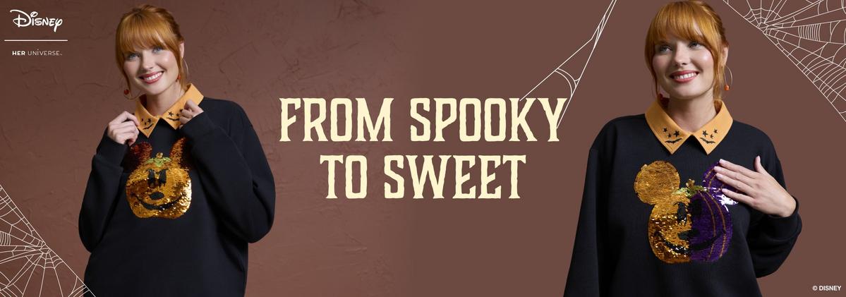 A woman wearing a black sweatshirt with a pumpkin design