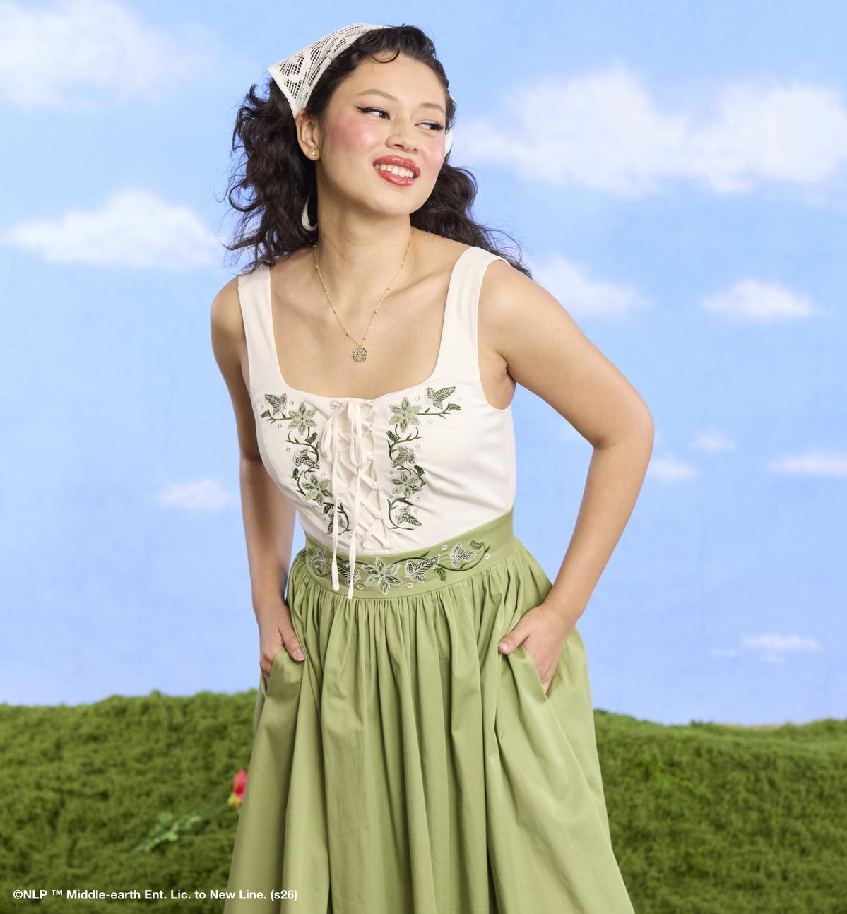 Woman wearing a green and white dress. Shop now