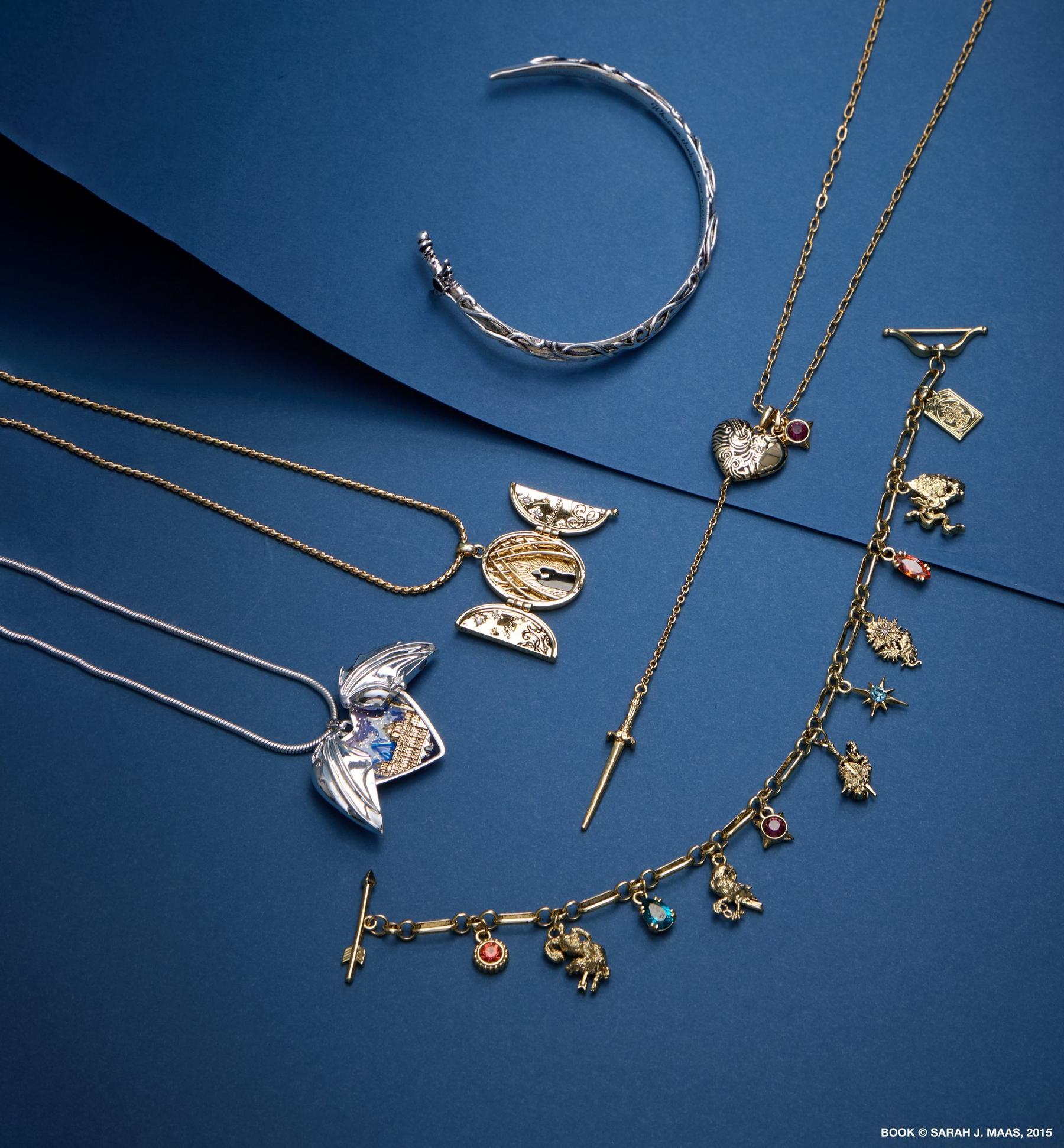 Assorted gold and silver necklaces and bracelets with charm and pendant details. Shop jewelry.