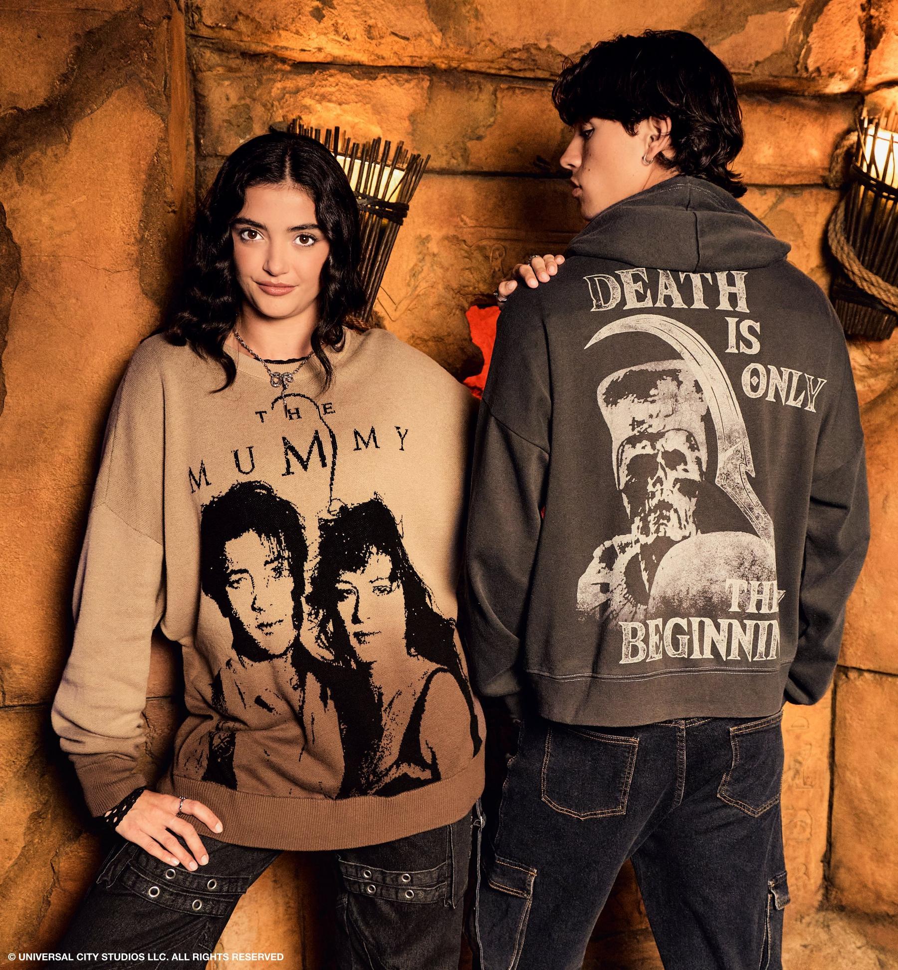 Two models wearing The Mummy graphic sweatshirt and “DEATH IS ONLY THE BEGINNING” hoodie. Shop The Mummy.