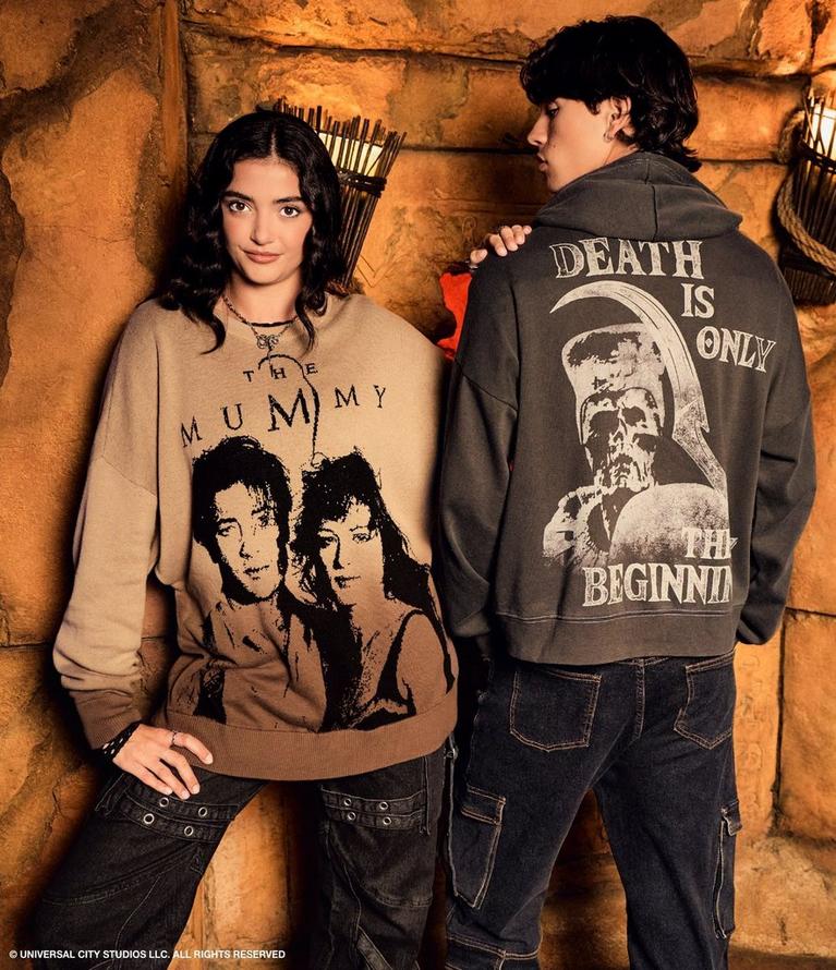 Two models wearing The Mummy graphic sweatshirt and hoodie with “DEATH IS ONLY THE BEGINNING” text. Shop The Mummy.