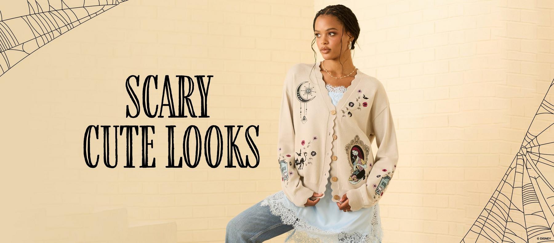 Model wearing embroidered cardigan with “SCARY CUTE LOOKS” text and spiderweb graphics. Shop The Nightmare Before Christmas.