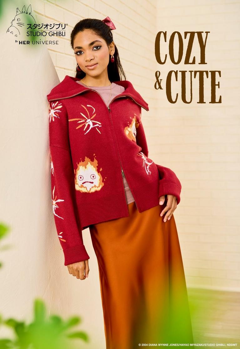 Model wearing Studio Ghibli by Her Universe red zip sweater with fire and character graphics. Shop Studio Ghibli.