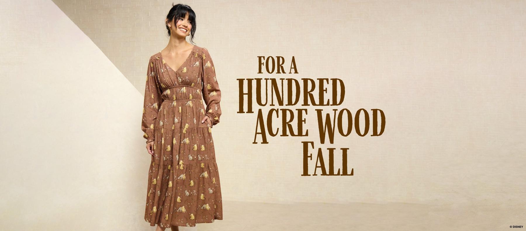 Model wearing a brown printed maxi dress beside text reading “FOR A HUNDRED ACRE WOOD FALL.” Shop Winnie the Pooh.