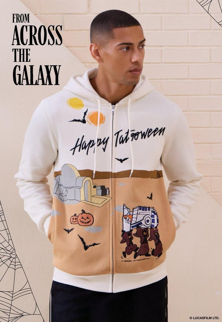 Model wearing a zip-up hoodie with “Happy Tatooween” text and Halloween Star Wars graphics. Shop Star Wars.
