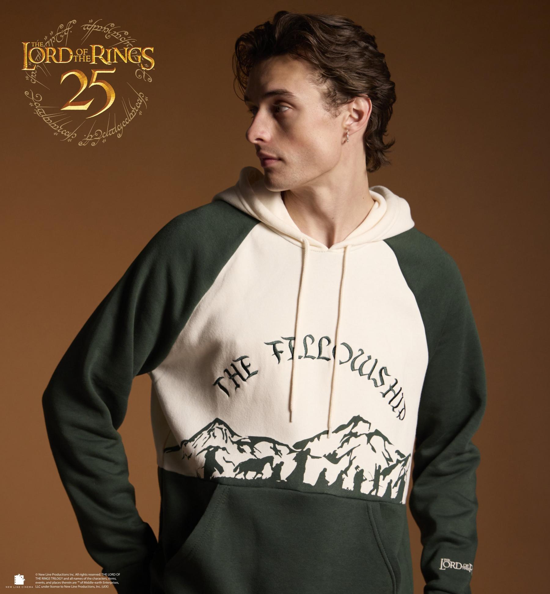 Model wearing The Lord of the Rings hoodie with “The Fellowship” text and mountain graphic. Shop The Lord of the Rings.