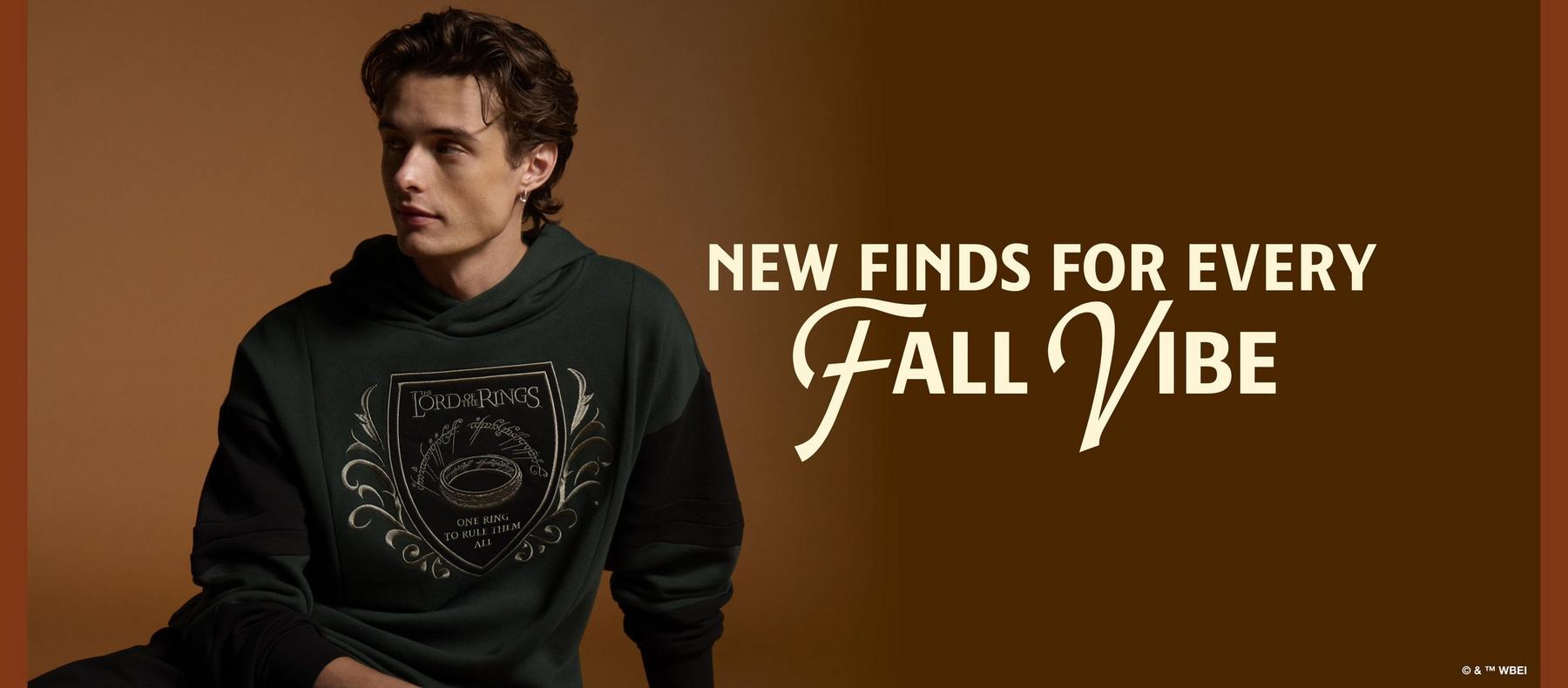 Man wearing The Lord of the Rings graphic hoodie with text “NEW FINDS FOR EVERY Fall Vibe”. Shop by license.