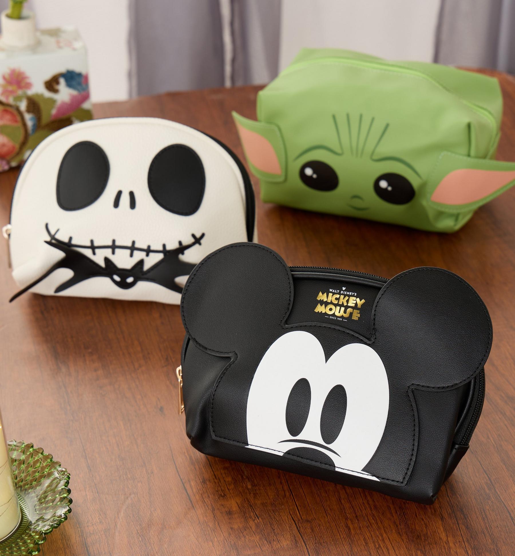 Three character makeup bags: Mickey Mouse, Jack Skellington, and Grogu designs. Shop beauty.