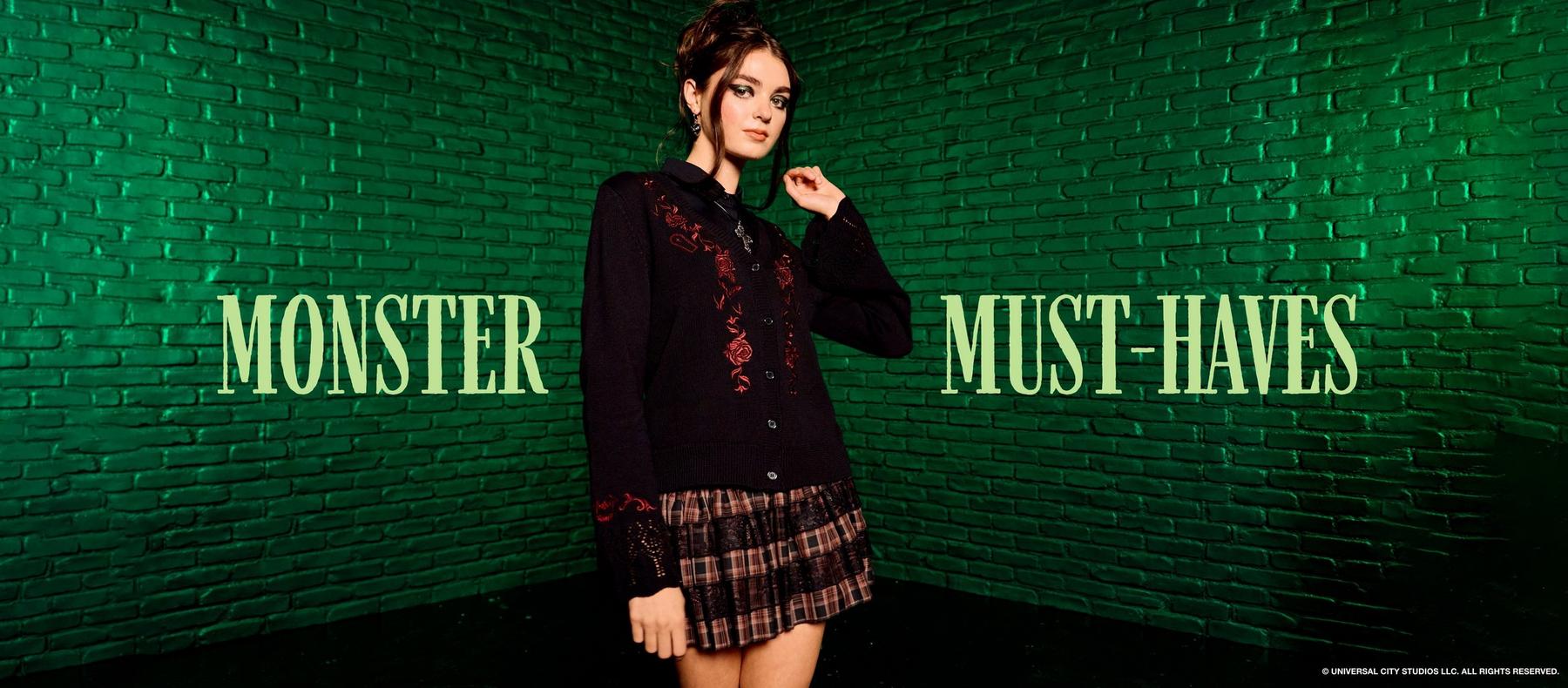 Model wearing a black embroidered cardigan and plaid skirt with text “MONSTER MUST-HAVES”. Shop Universal Monsters.
