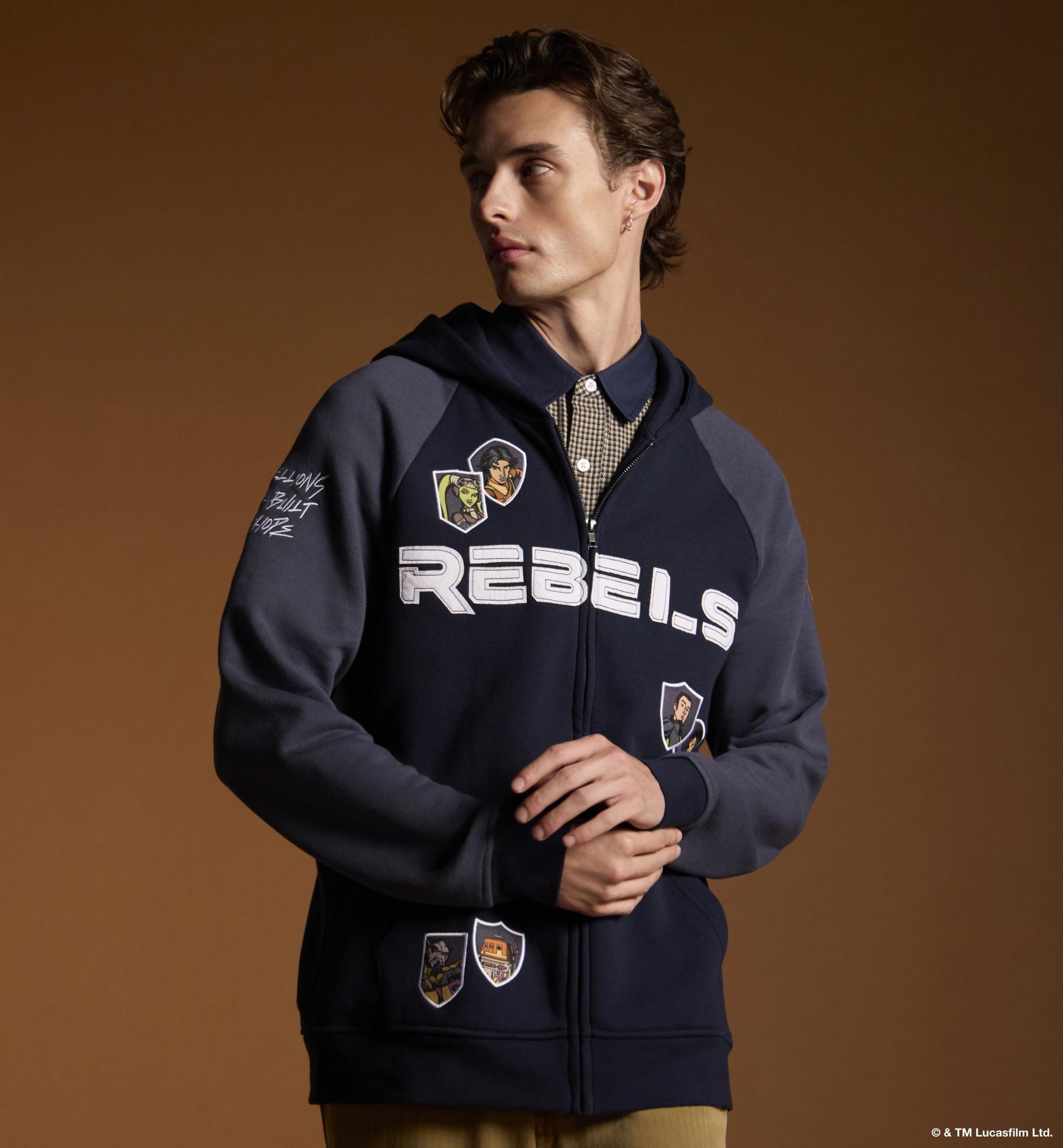 Model wearing a zip-up hoodie with character patches and “REBELS” text across the chest. Shop Star Wars.