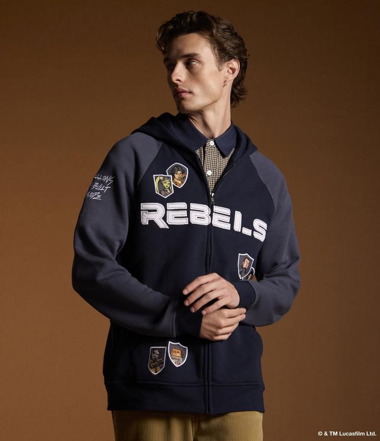 Model wearing a zip-up hoodie with “REBELS” text and character patches. Shop Star Wars.