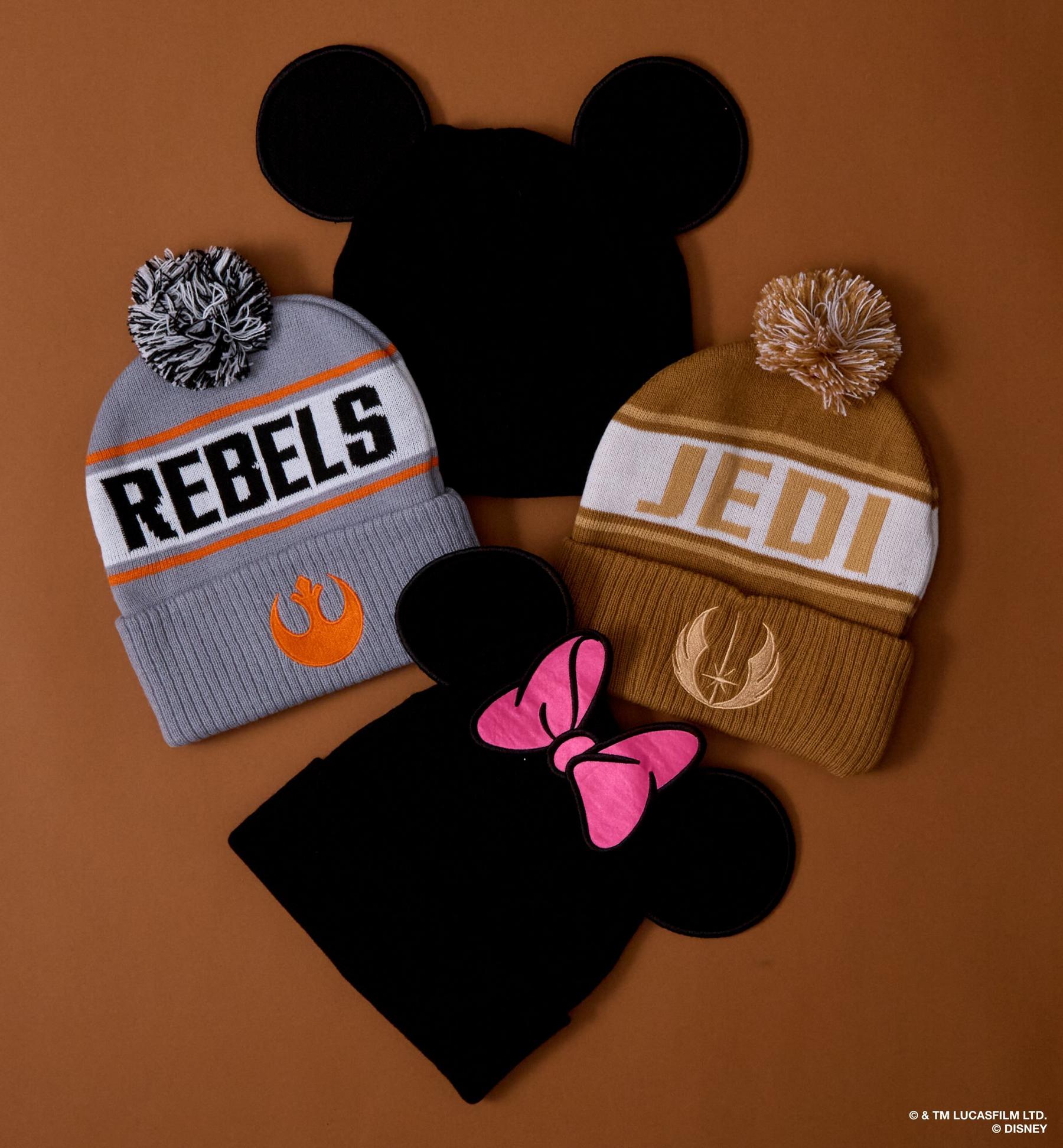 Two pom-pom beanies with REBELS and JEDI text and Star Wars logos. Shop cold weather accessories.