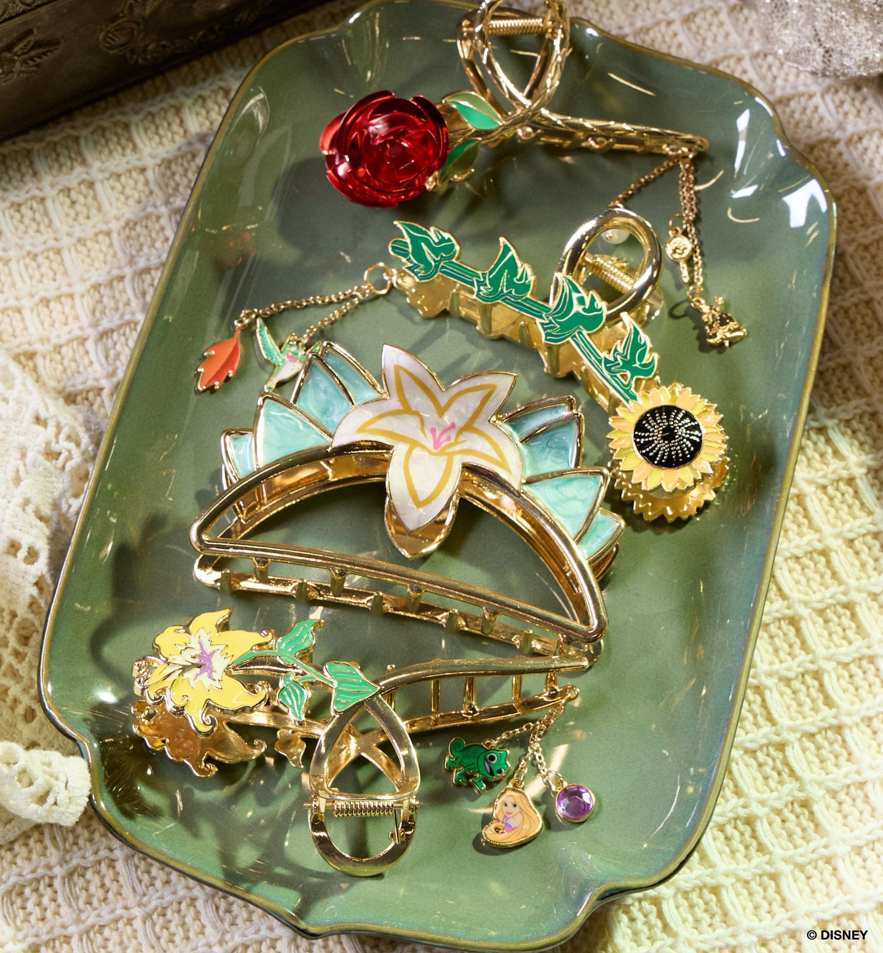 Disney floral hair clips and charms arranged on a dish. Shop hair accessories.