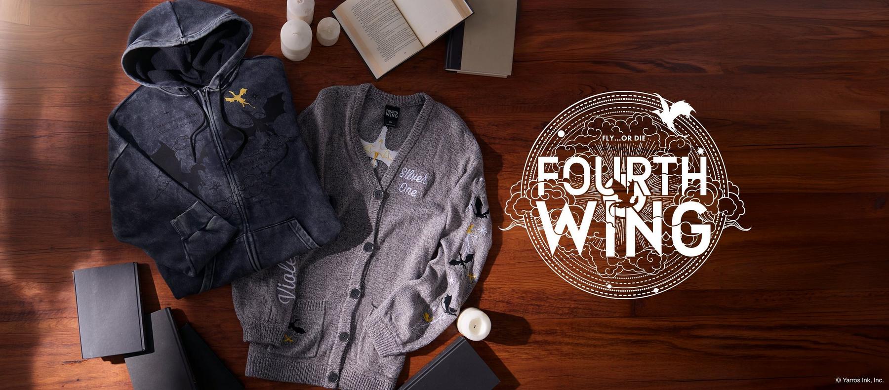 Fourth Wing hoodie and cardigan laid out with books and candles, plus Fourth Wing graphic text. Shop Fourth Wing ocllection.
