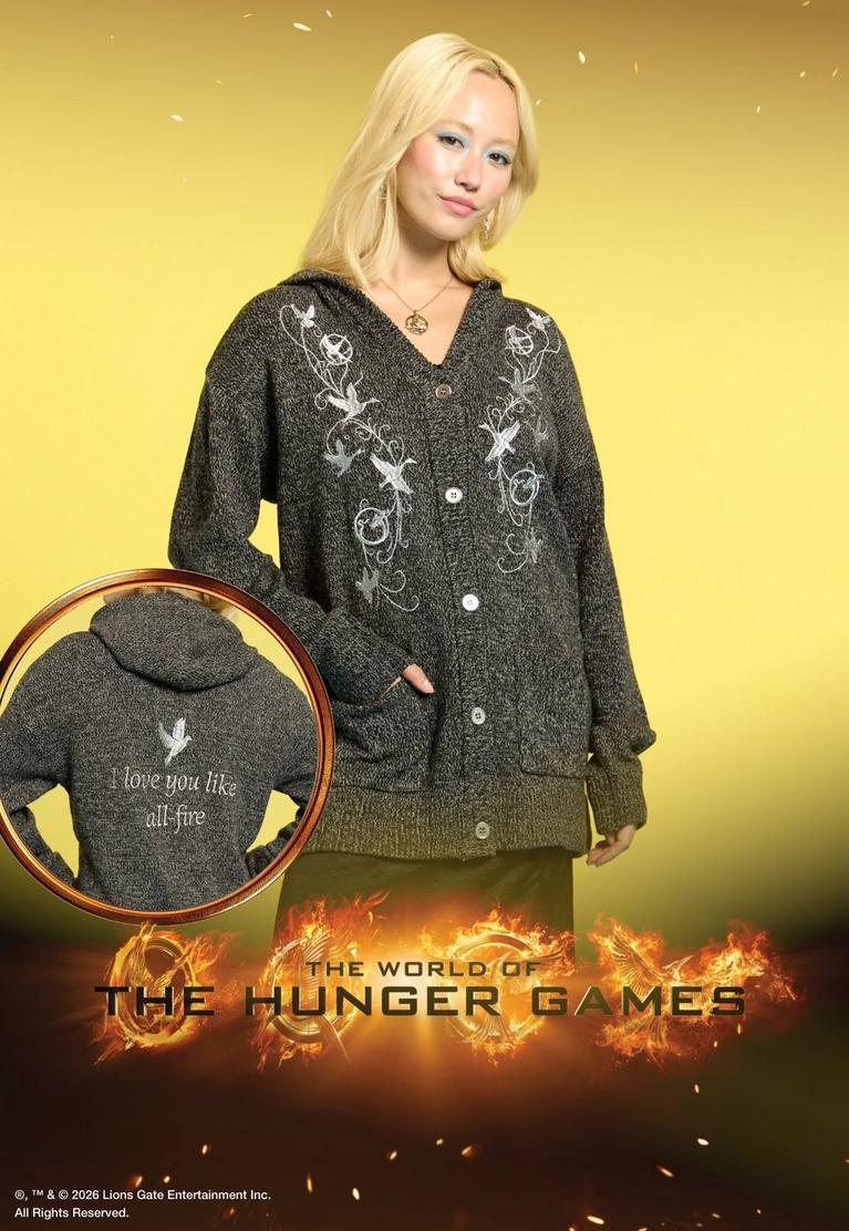 Model wearing a gray embroidered button-up hoodie, with inset showing back text "I love you like all fire.". Shop The Hunger Games collection.