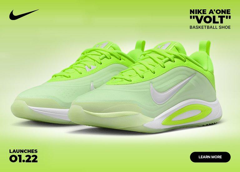 A promotional banner for the Nike A'One "Volt" Basketball Shoe featuring a pair of vibrant neon green and lime sneakers. The design includes a white Nike swoosh and a "Launches 01.22" date in the bottom left corner.