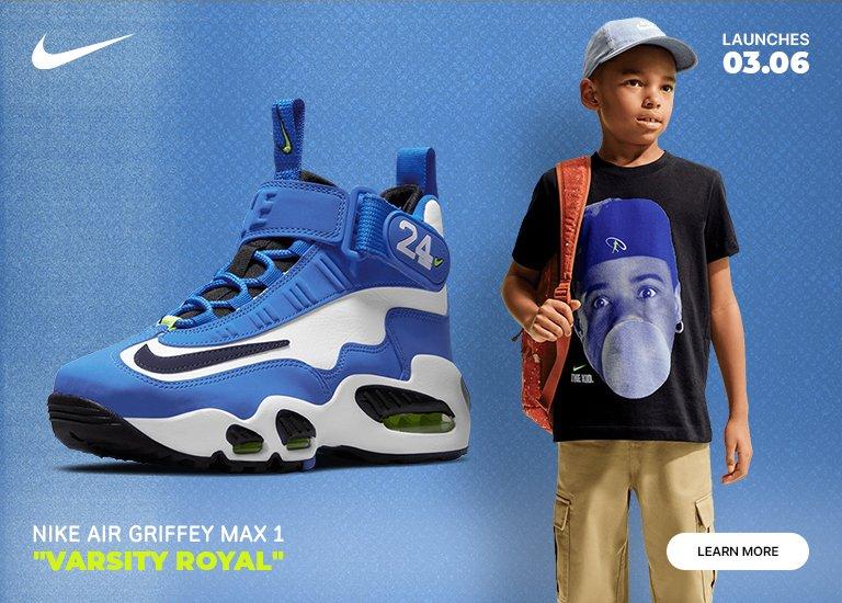  A promotional graphic for the Nike Air Griffey Max 1 "Varsity Royal" sneaker launch on 03.06. On the left, a high-top blue, white, and black sneaker with neon green accents is featured. On the right, a young boy wears a matching blue cap, khaki cargo pants, and a black T-shirt featuring a graphic of Ken Griffey Jr. blowing a bubble.