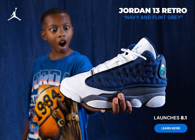 Jordan 13 Retro "Navy and Flint Grey" sneaker with launch date and learn more call-to-action.