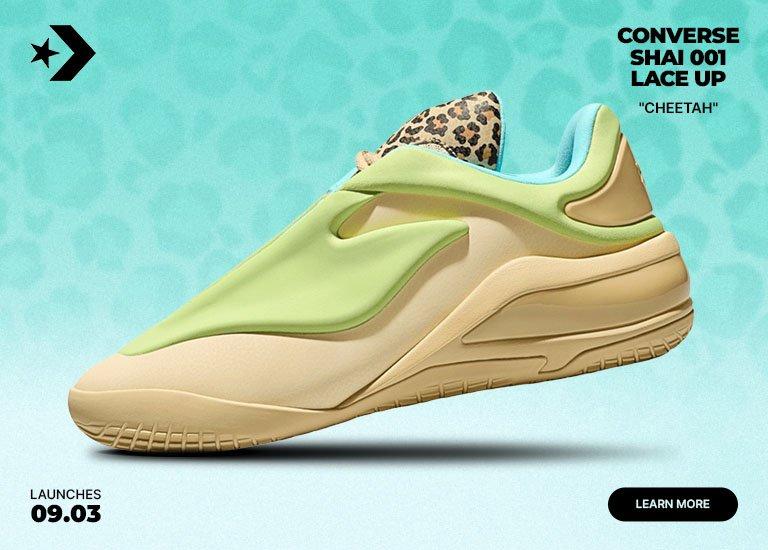 Converse SHAI 001 "Cheetah" sneaker in light green and cream with a sculpted slip-on design, teal lining, cheetah-print tongue detail, and gold heel accent against a turquoise background.