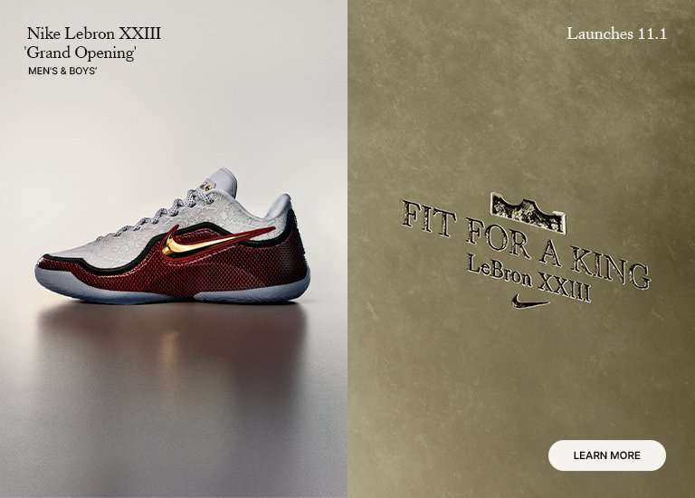 Profile view of a Nike LeBron XXIII 'Grand Opening' sneaker in white, deep red, and gold, next to a gold panel with the embossed text 'FIT FOR A KING.'