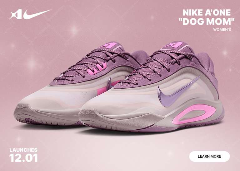 A promotional image for the Nike A'One Dog Mom women's shoe, featuring a pair of pink and lavender sneakers with metallic accents on a sparkly pink background. The text indicates a launch date of 12.01.