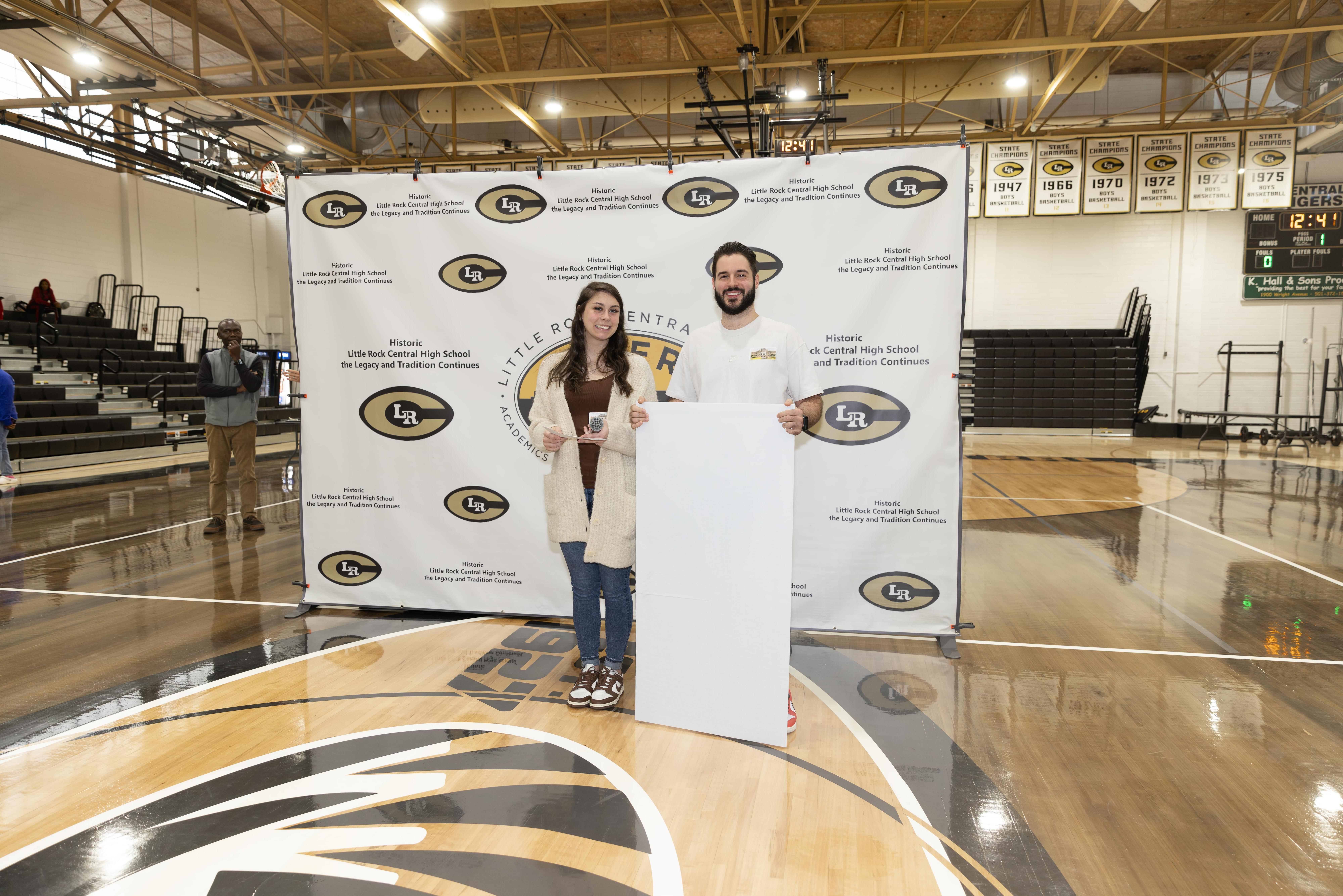 Hibbett store representatives presenting $5000 Support Her Sole donation check