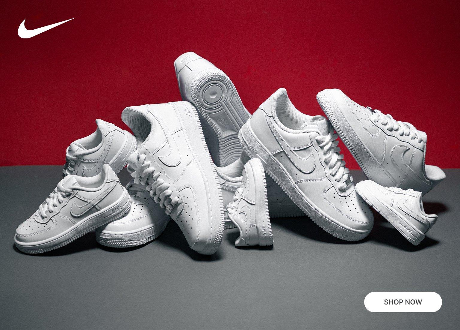 White Nike Air Force 1 sneakers in kids, women’s and men’s sizes on a red background.