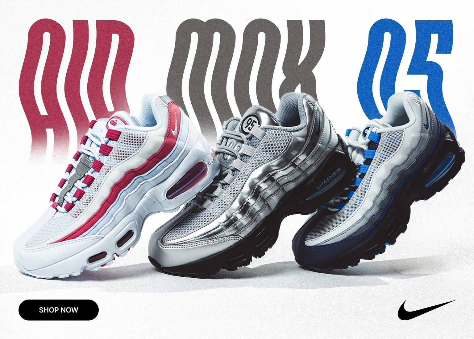 Promotional banner for the Nike Air Max 95, showcasing three different colorways: a white and pink pair, a metallic silver and black pair, and a white, grey, and blue pair. The background features stylized, wavy "AIR MAX 95" text in red, grey, and blue gradients. A "SHOP NOW" button is in the bottom left, and a black Nike swoosh is in the top right.