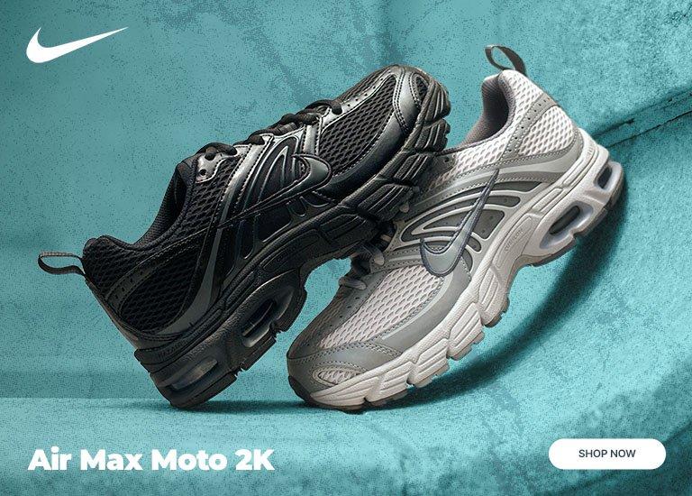 Nike Air Max Moto 2K sneakers in black and white colorways with mesh uppers and visible Air cushioning.