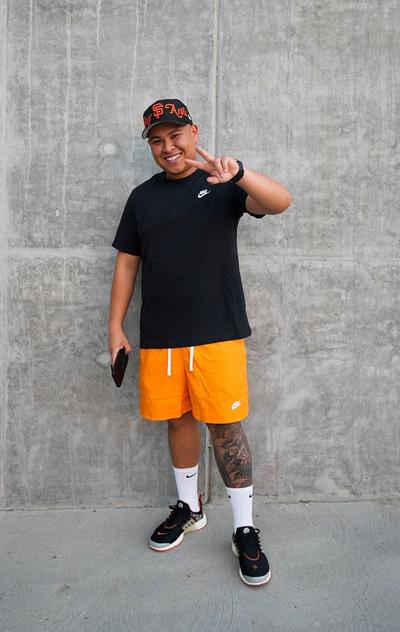 Alex Walter posing in Nike flow shorts and a tee