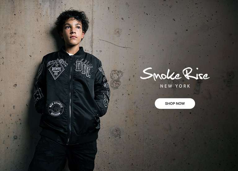 Smoke Rise New York banner featuring boy modeling a black satin bomber jacket with white patches and lettering. Text reads 'Smoke Rise New York' with a Shop Now button.