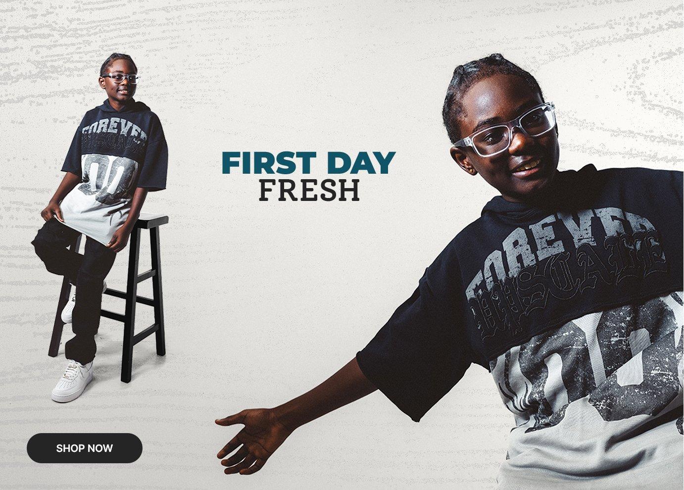 Kids' first-day style featuring an oversized graphic tee, black denim, and white sneakers.