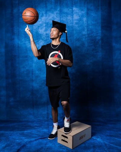 Young man in Jordan apparel spinning basketball om finger
