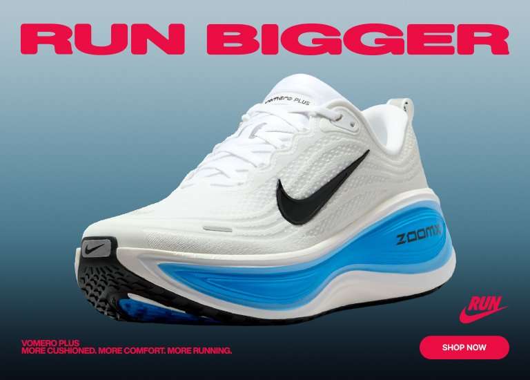 White and blue Nike Vomero Plus running shoe against a blue-gray background with the text RUN BIGGER and a Shop Now button.