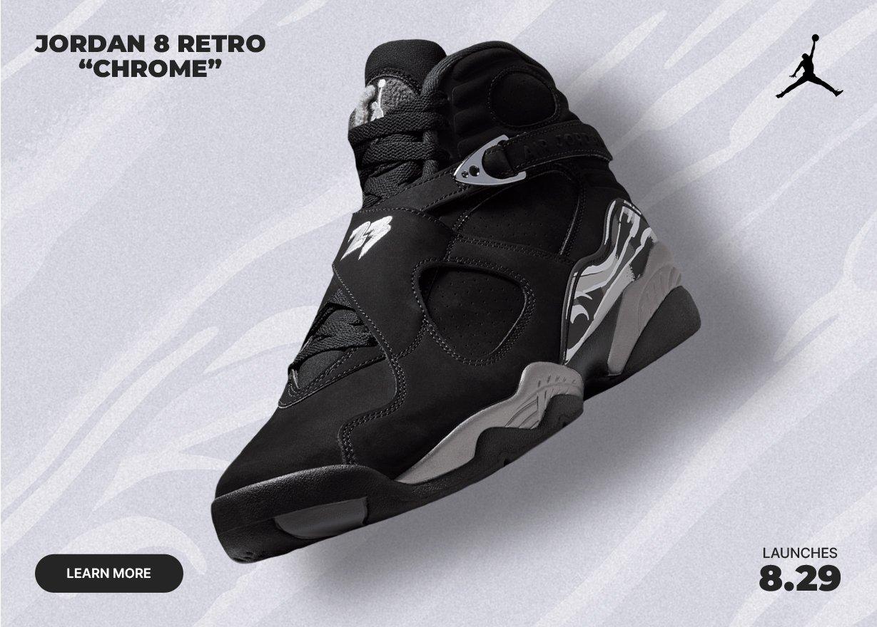 Jordan 8 Retro “Chrome” sneaker in black and gray with chrome accents displayed against a textured gray background, featuring launch date graphics and Jumpman branding.