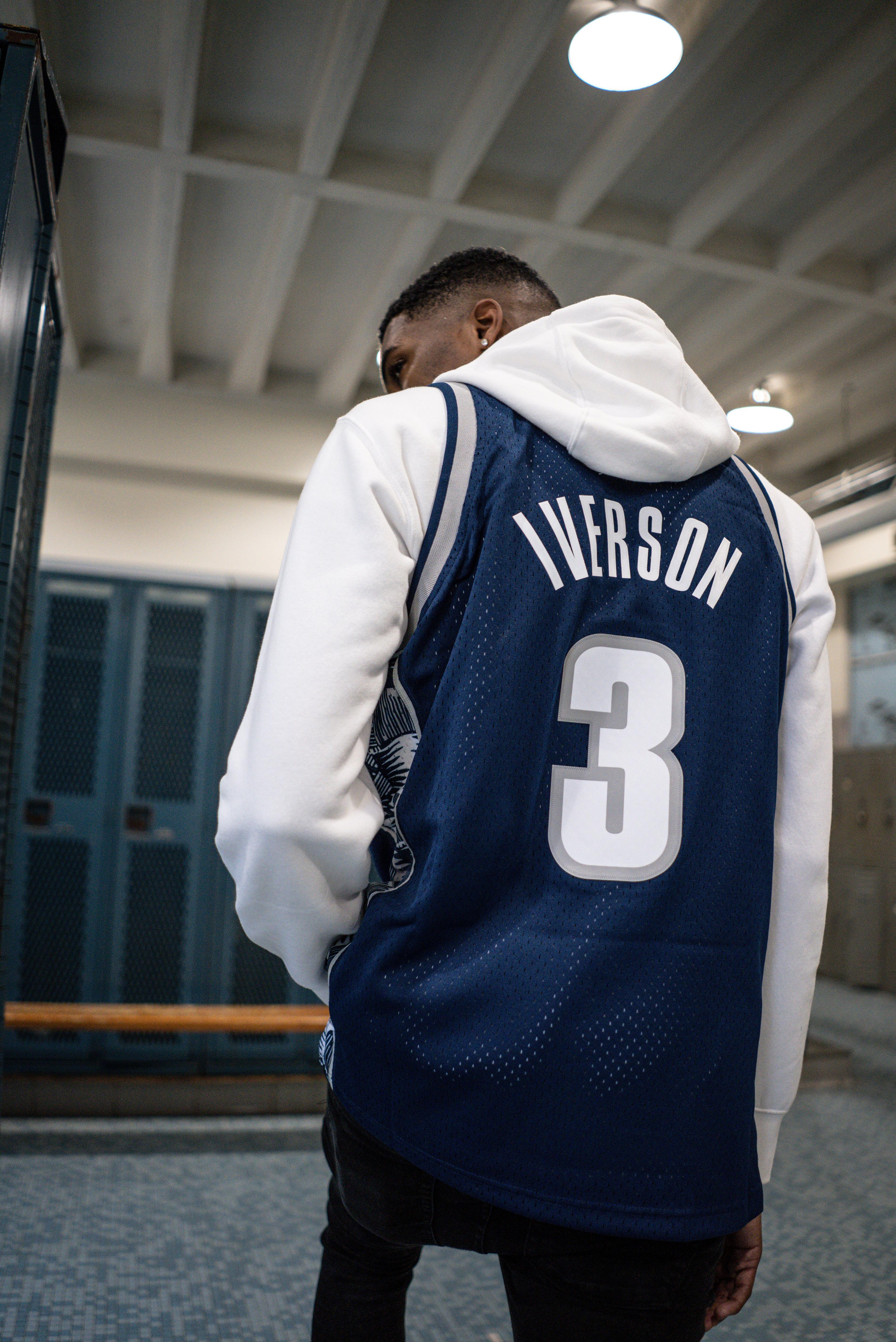 allen iverson wearing his new jersey over his draft day suit will