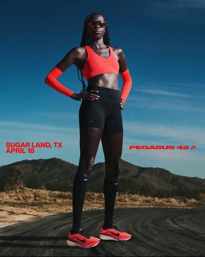Woman wearing Pegasus 42 running shoes on road in mountain setting