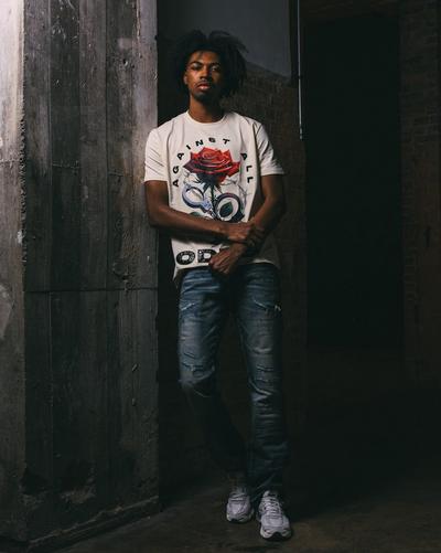 Young man in Streets Is Watchin shirt and Nike Air Max Moto 2K