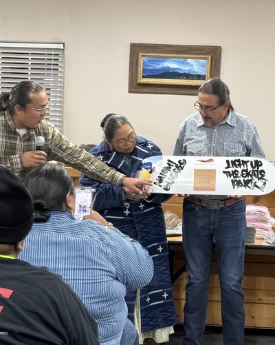 Glasses-presented-commemorative-board-at-light-up-the-park-celebration