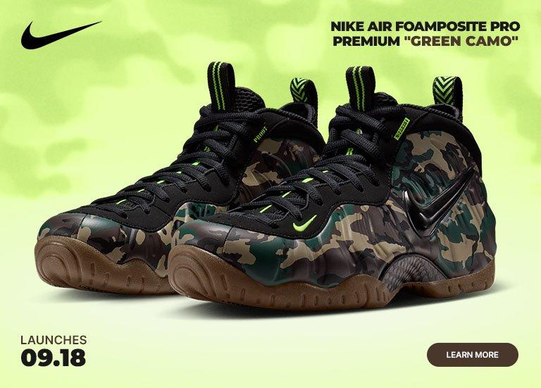 Nike Air Foamposite Pro Premium Green Camo sneakers with camouflage-print upper, black laces, bright green accents, and gum rubber outsole displayed against a bright background.