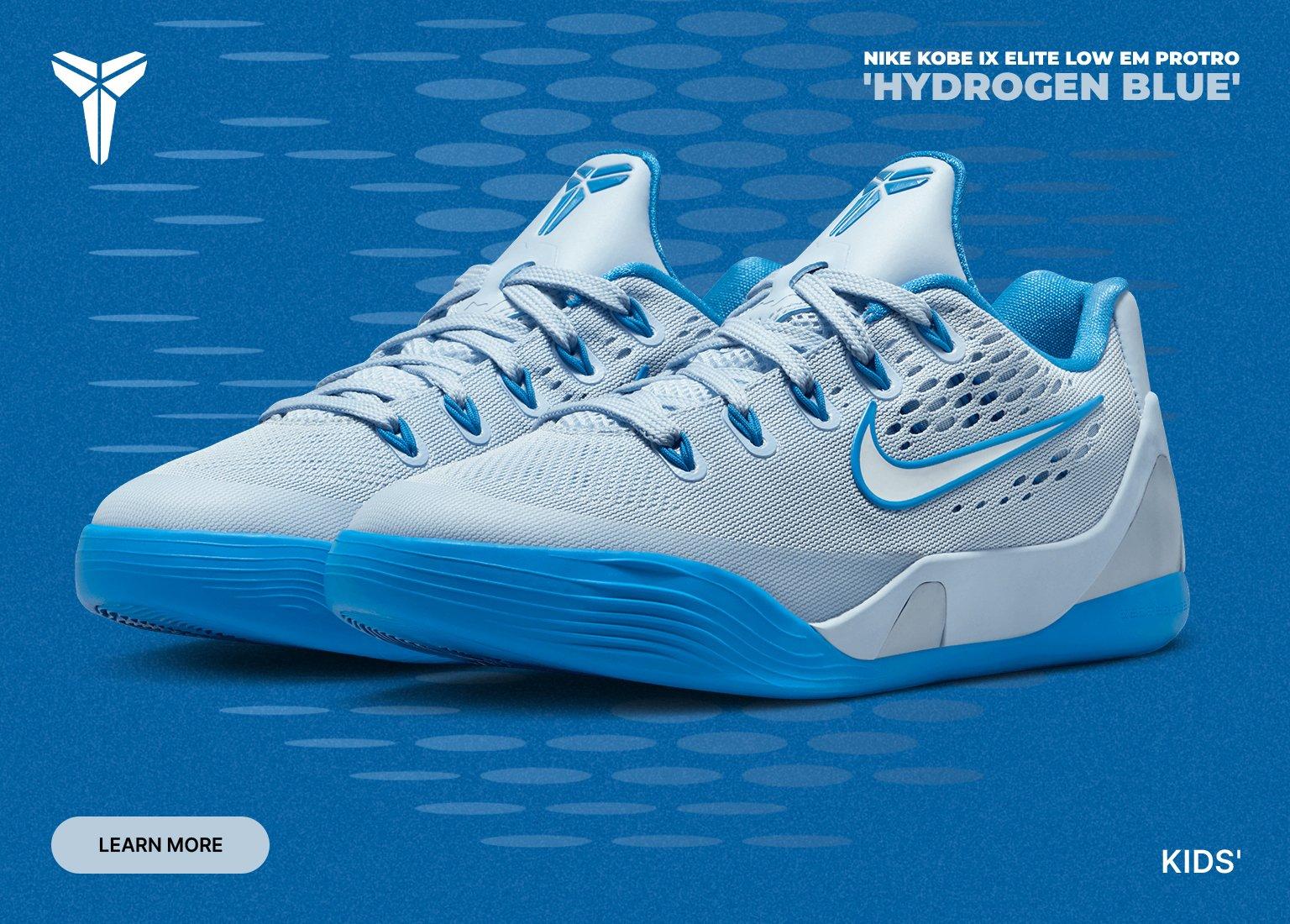 A promotional graphic for the Nike Kobe IX Elite Low EM Protro in 'Hydrogen Blue.' The image features a pair of light blue and cyan basketball sneakers against a textured blue background, with the Kobe Bryant "Sheath" logo in the top left and "KIDS'" in the bottom right.